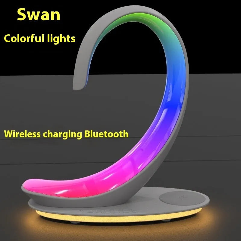 White swan shaped desk lamp with wireless charging pad and Bluetooth speaker featuring multi-colour lighting