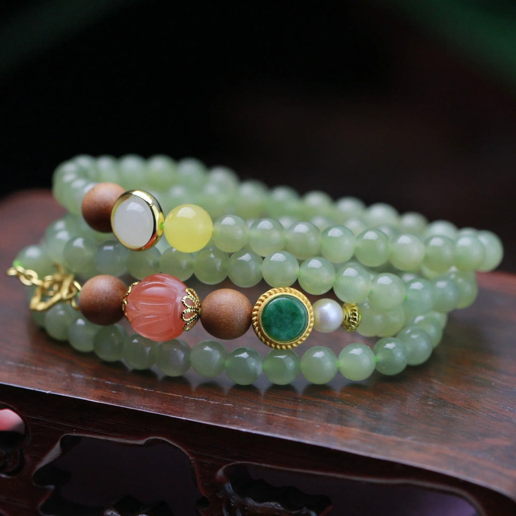 Natural Hetian jade necklace with red lotus beads, white sandalwood, and beeswax accents; unisex design with fu character motif