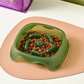 Blue plastic dog slow feeder bowl with raised internal maze pattern for anti-choking feeding