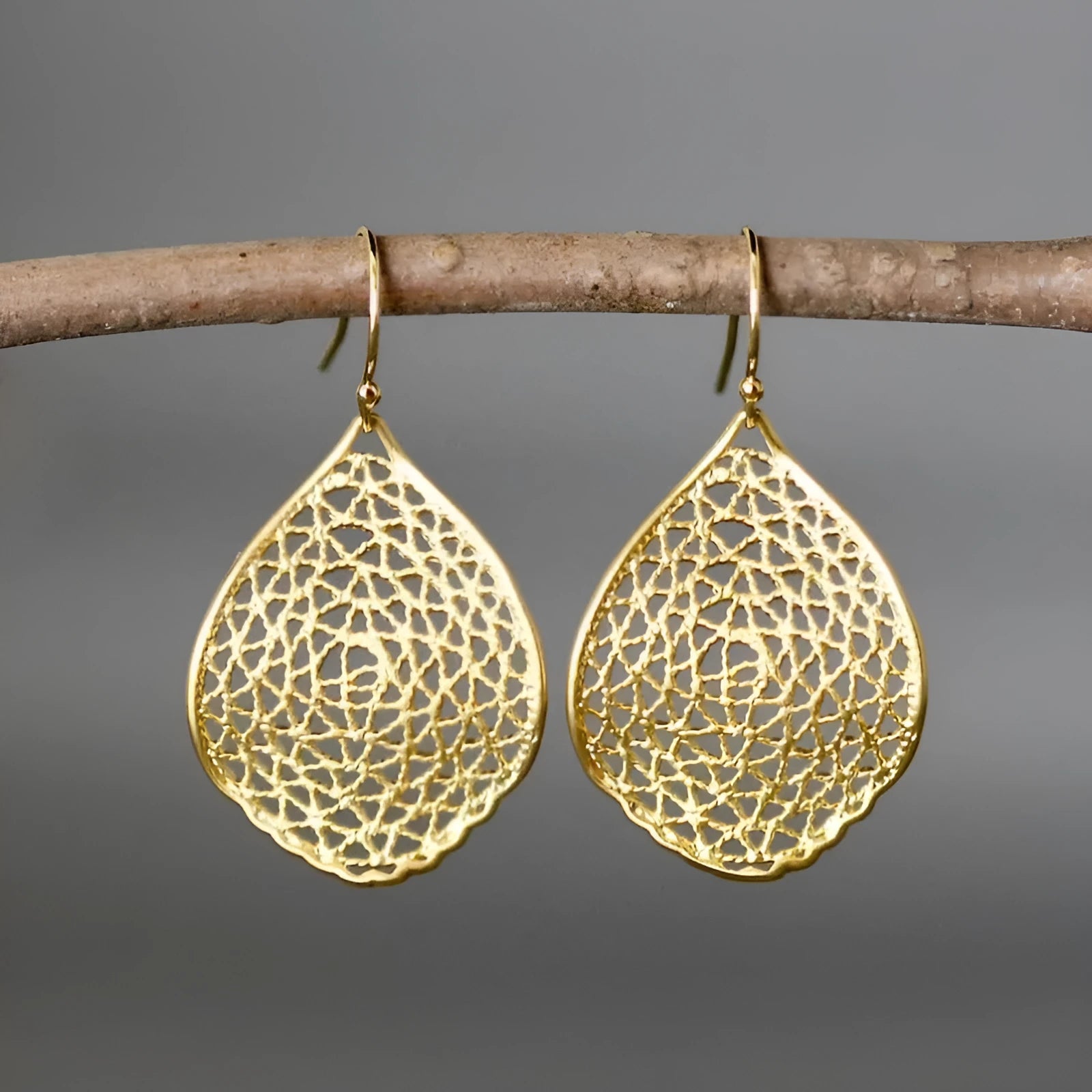 Gold retro leaf hollow pendant drop earrings showing openwork design