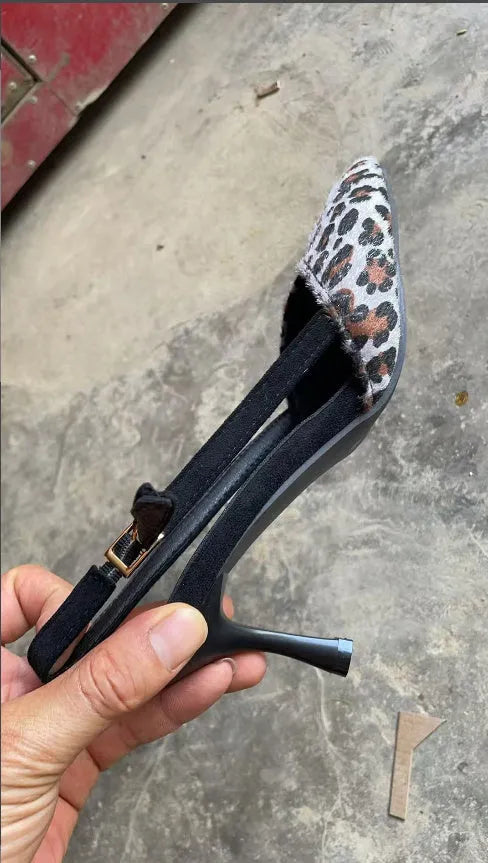 Women's leopard print suede sandals with a pointed toe and high heel.