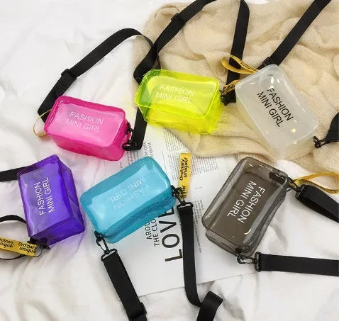 A transparent square jelly crossbody bag with a single adjustable shoulder strap.