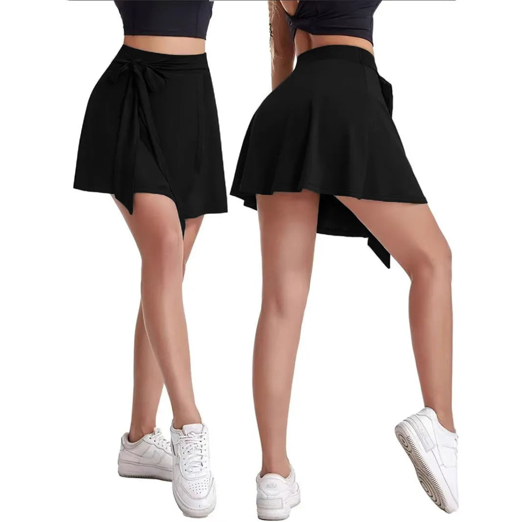 Black thigh-length sports skirt with built-in shorts, showing high waist and culotte style.