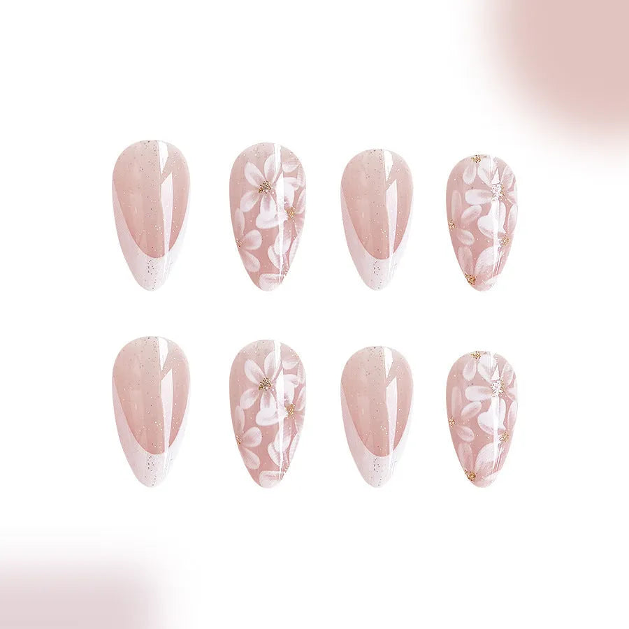 Short almond French manicure press-on nails with pink glitter finish and floral designs