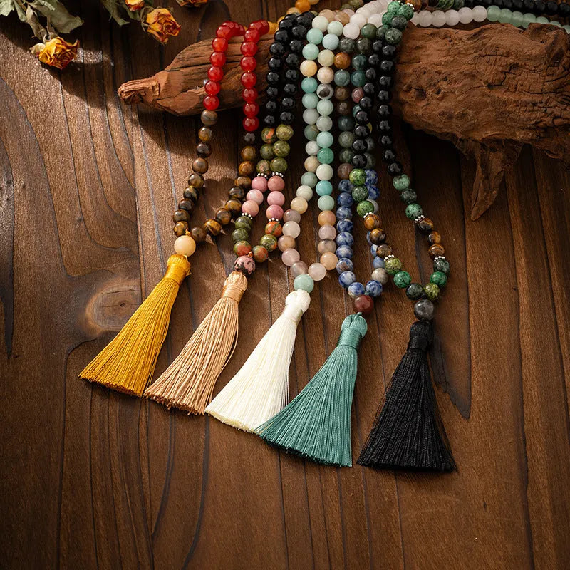 Vintage bohemian style beaded long necklace with matching bracelet showing geometric ball bead construction and tassel detail