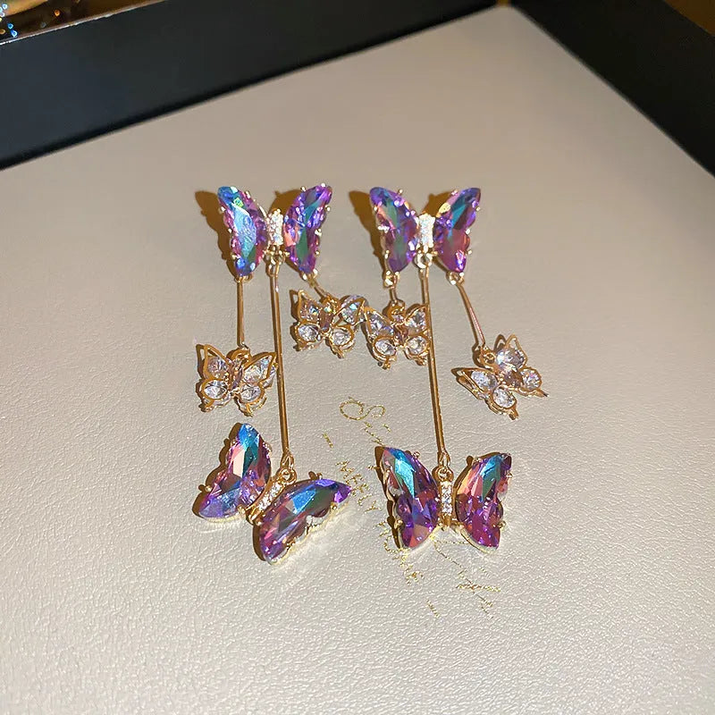 Silver needle finish blue purple butterfly and crystal flower drop tassel earrings for women.