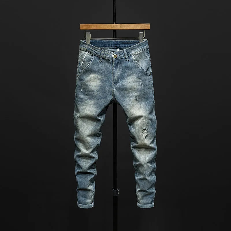 Men's dark blue skinny jeans with a slim fit and mid waist, laid flat.