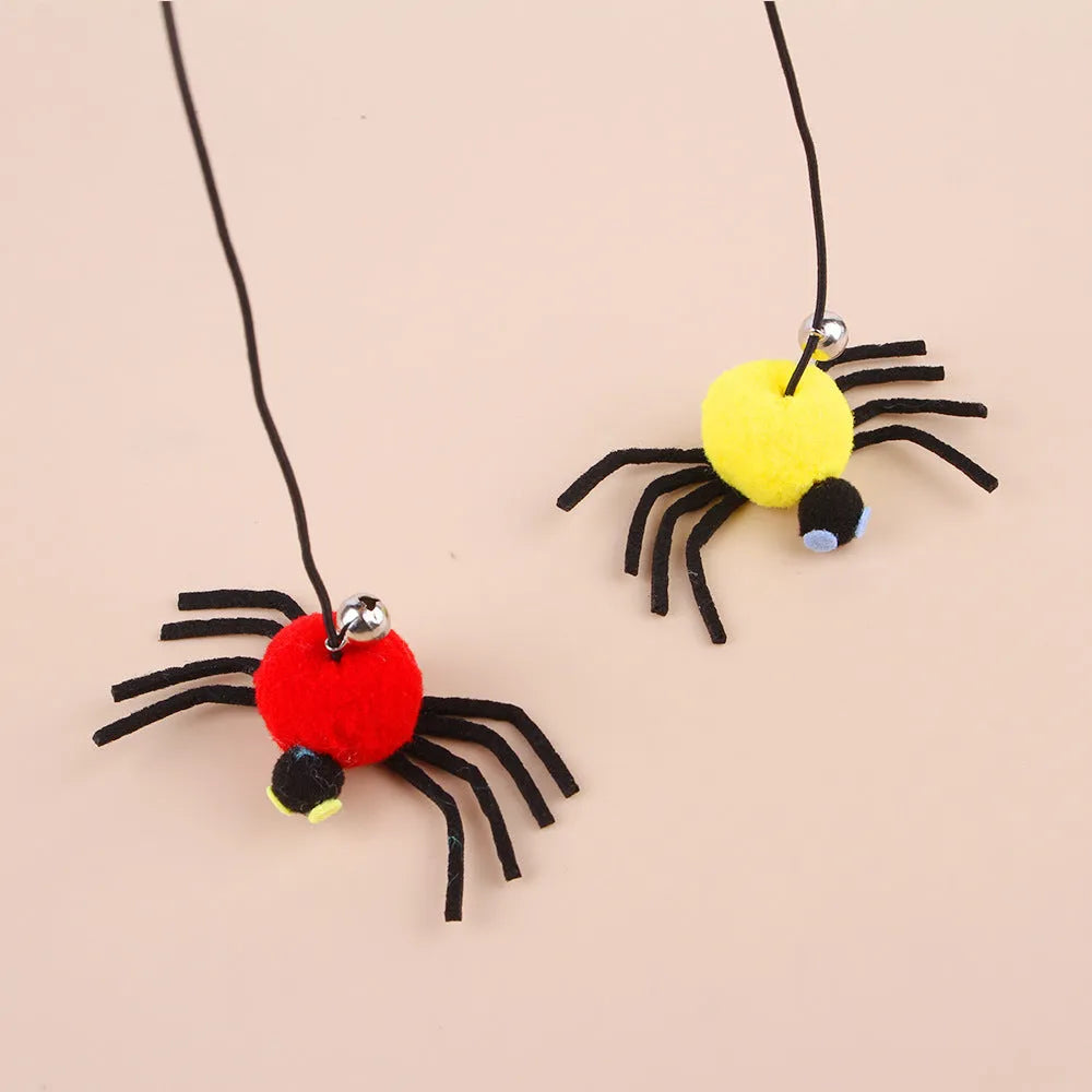Red and yellow cat door toy with elastic rope, feather, bell, and spider dangling for interactive play.