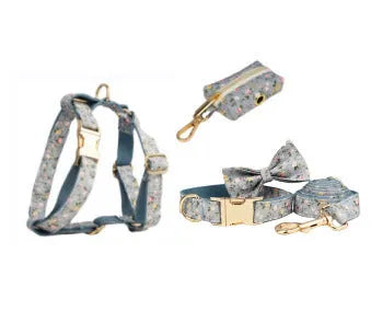 Blue floral patterned cloth dog collar with matching leash and vest set on a white background.