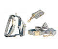 Blue floral patterned cloth dog collar with matching leash and vest set on a white background.