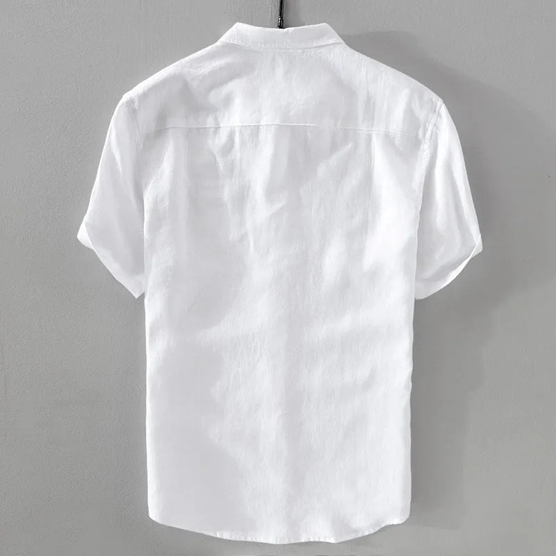 Man wearing a loose-fit short sleeve linen shirt in a solid colour.
