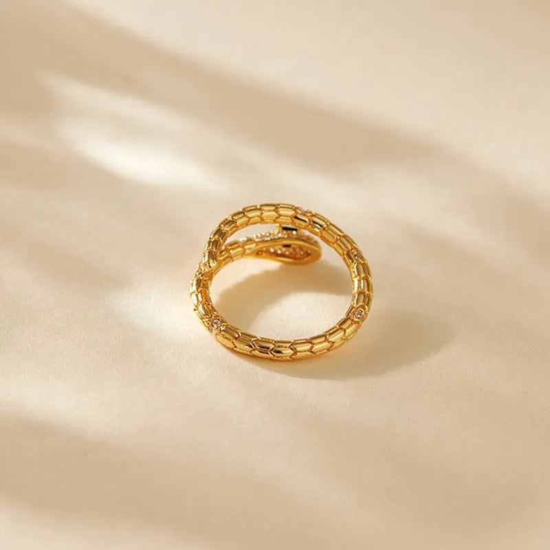 Snake-shaped adjustable copper ring with gold colour plating and diamond treatment