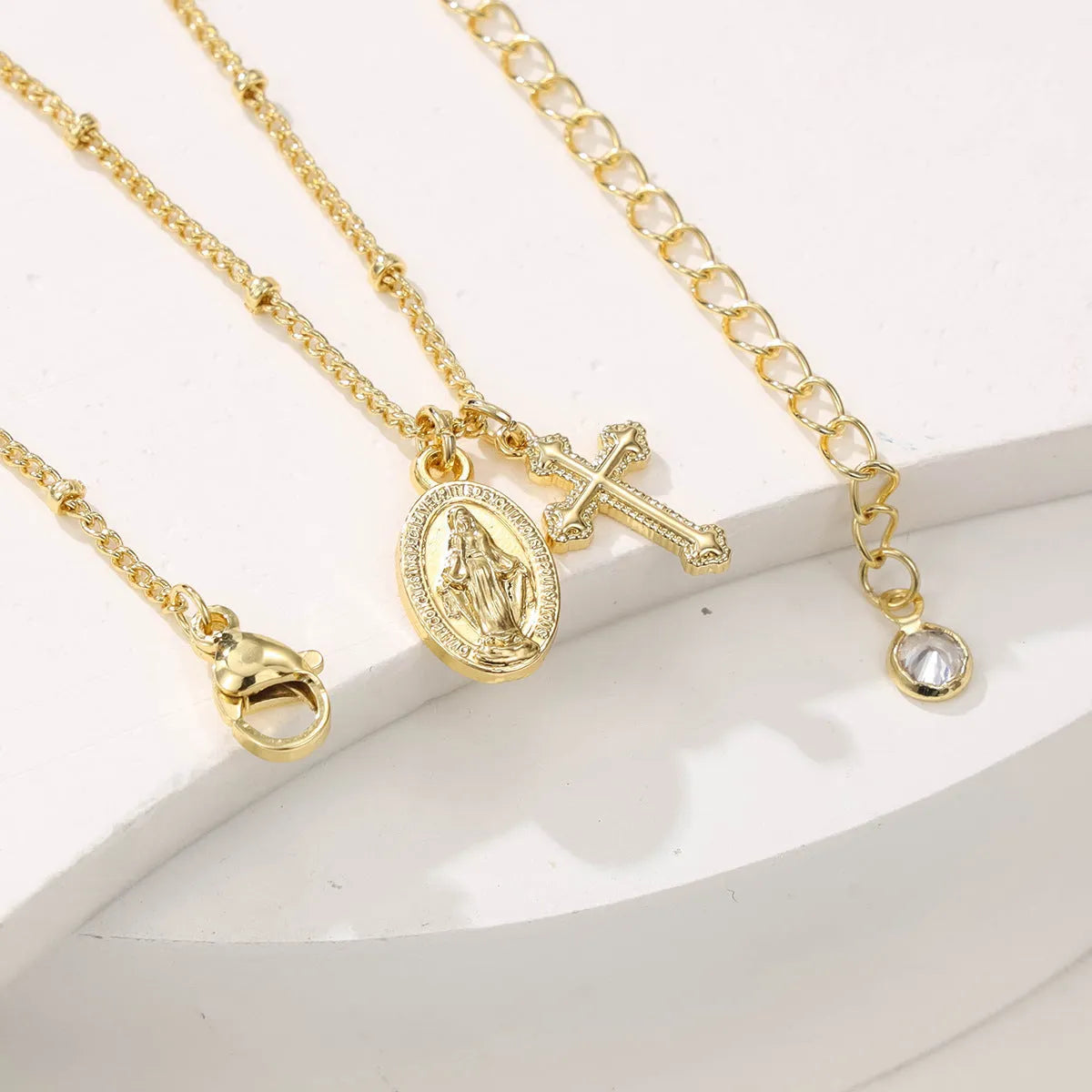 Gold cross pendant necklace with Virgin Mary ornament on geometric 2.5 cm pendant