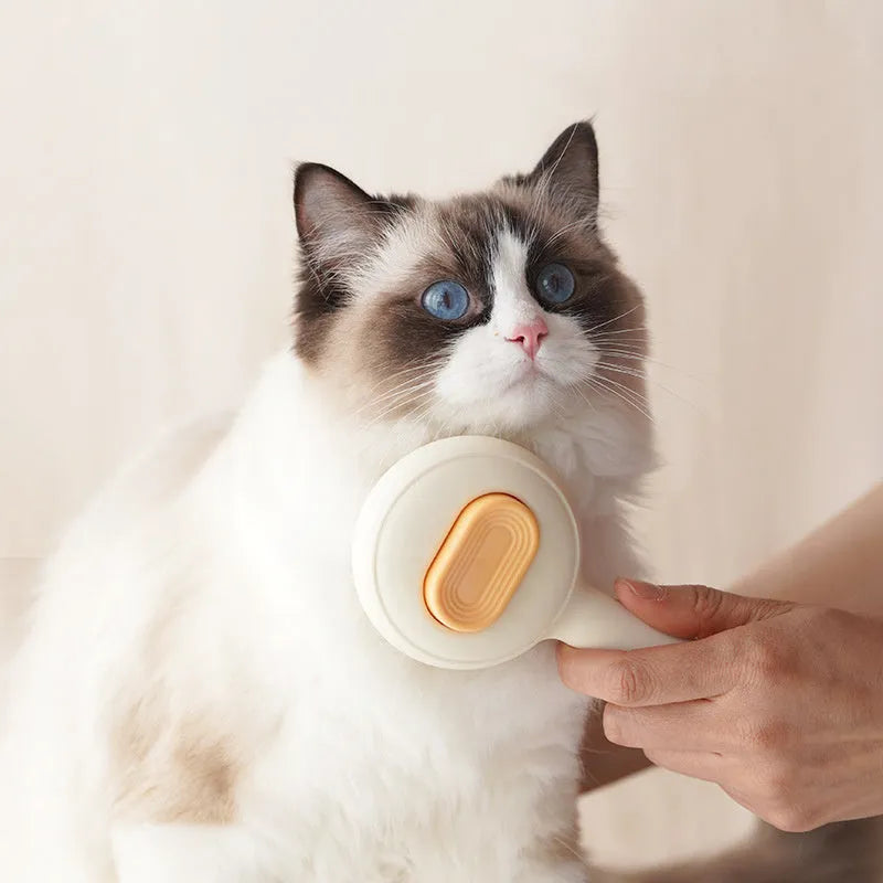 Green stainless steel cat grooming brush with non-slip handle removing loose pet hair