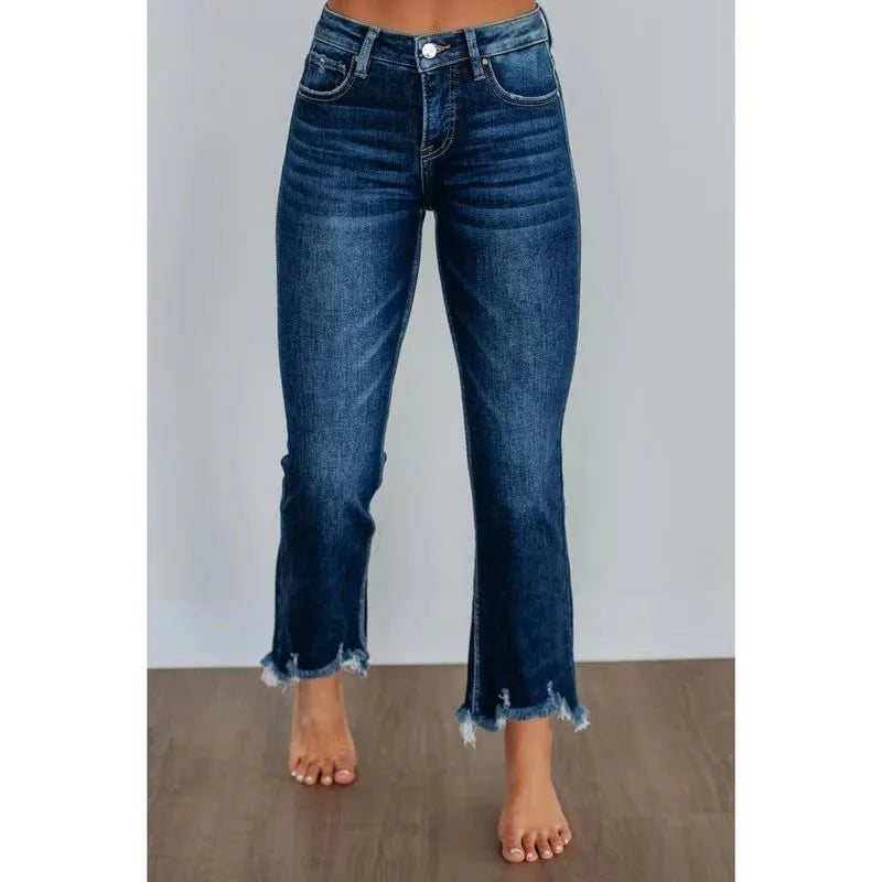 Women's solid colour denim jeans with hand-worn distressing in dark blue on a model