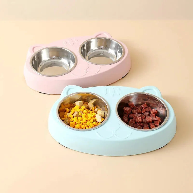 Blue macaron-shaped plastic pet feeder with two separate bowls for food and water.