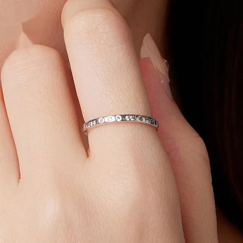 Silver ring with oxidised black moss texture and I Love You engraving on band.