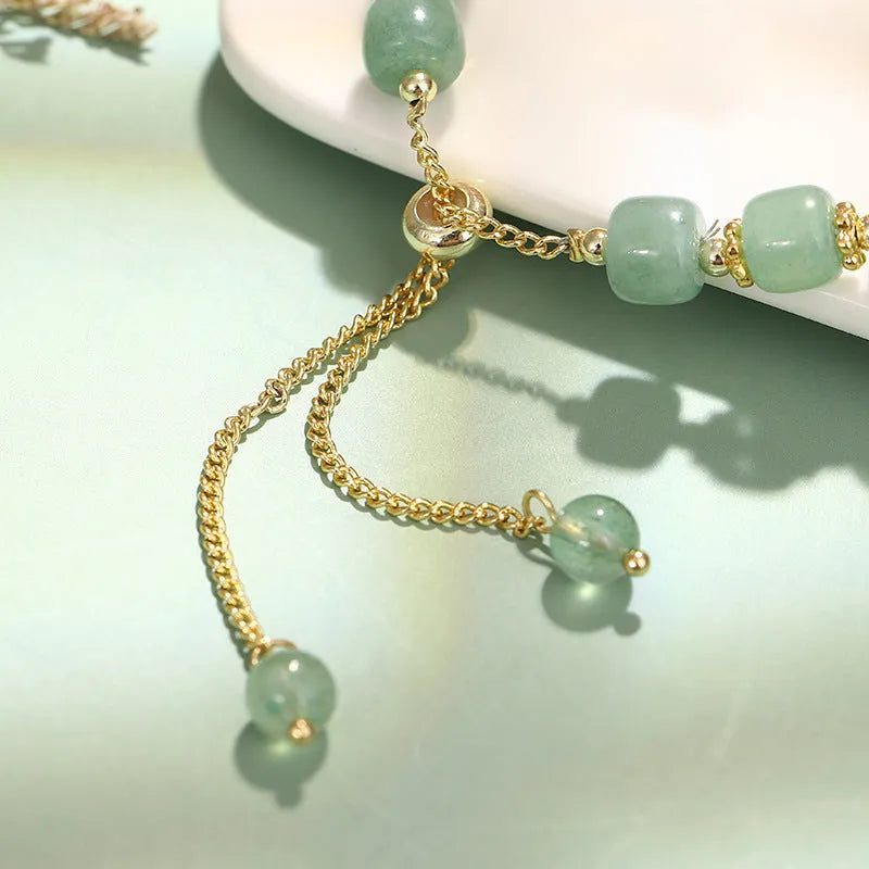 Rabbit charm bracelet with green aventurine stone on copper and gold chain.