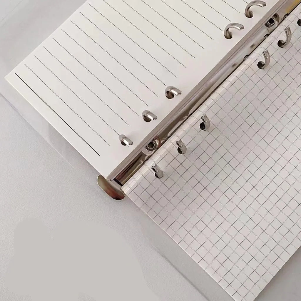 A6 size loose-leaf coil notebook with heart-themed bear design, showing coil binding and 6-hole edge.