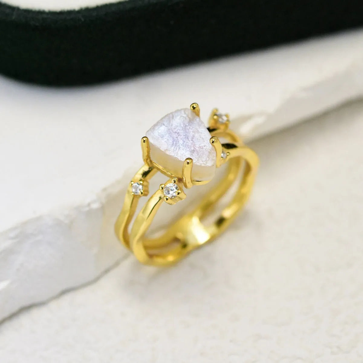 S925 silver ring with an irregular triangle shape holding a moonstone, shown in a rose gold electroplated finish.