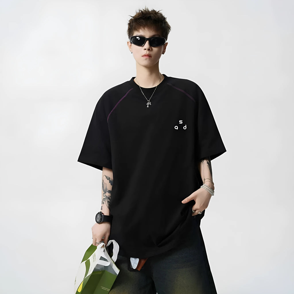 Man's loose fit black cotton T-shirt with large white letter print on the front.