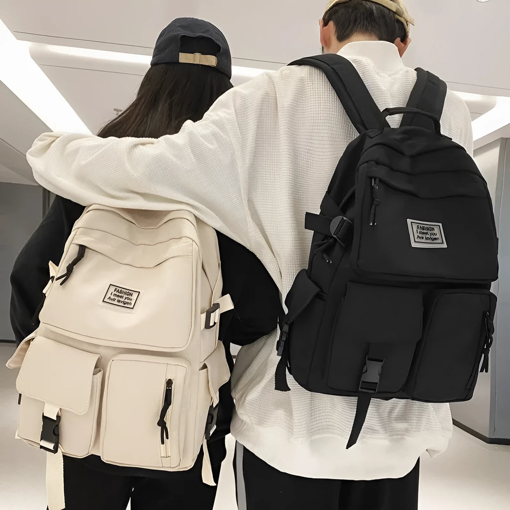 Black and white soft nylon student backpack showing external pockets and internal laptop compartment.