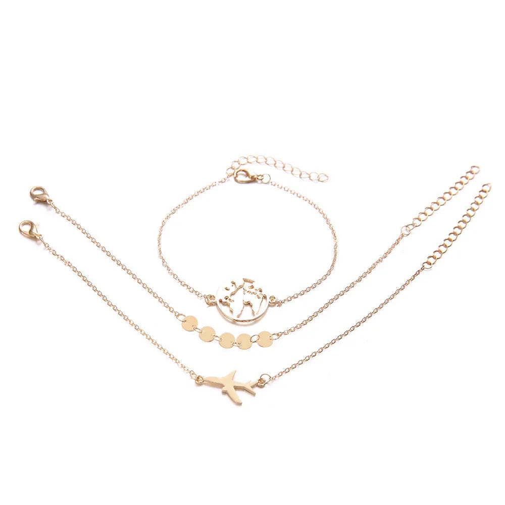 Set of three women's alloy bracelets with heart-shaped aircraft map charms.