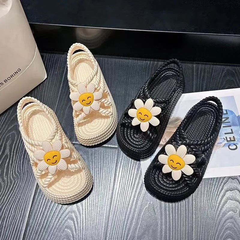 Beige PVC sandals with a round toe, sunflower design, and non-slip sole.