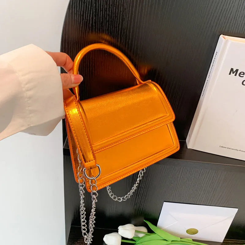 Square-shaped PU leather crossbody bag in multiple colour options on a model.
