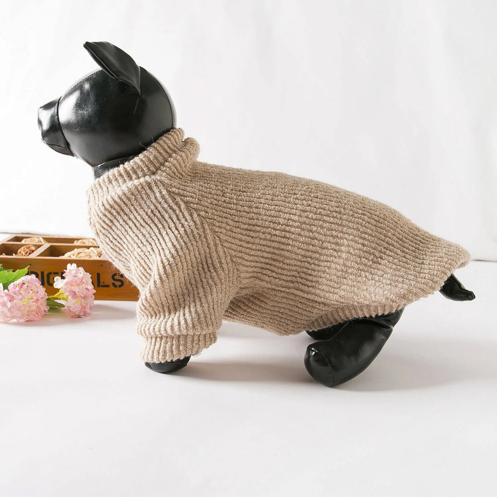 Brown knitted dog sweater on a small white dog, showing a casual pullover style.
