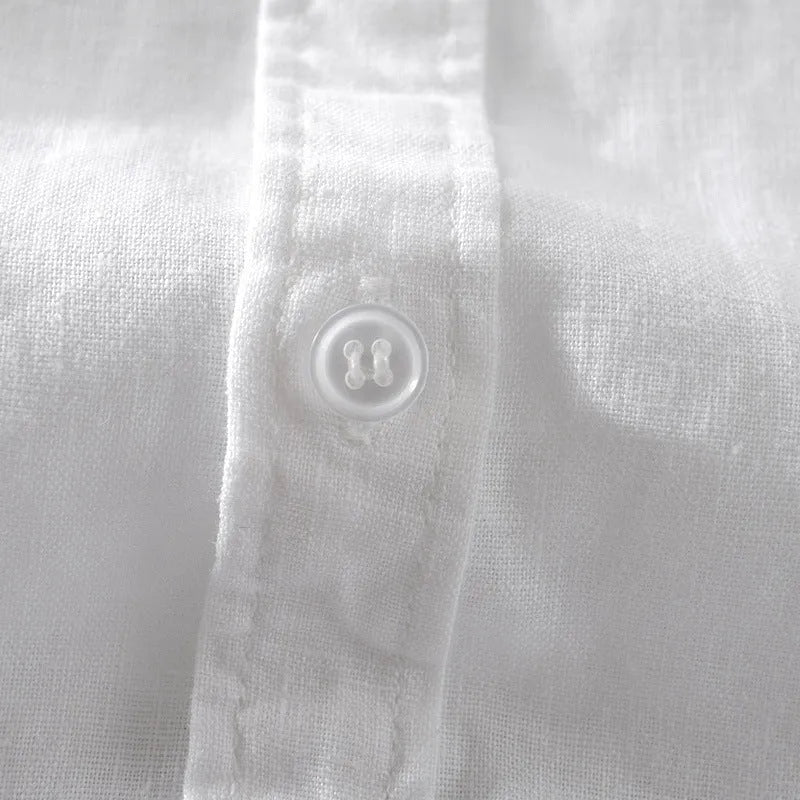 Man wearing a loose-fit short sleeve linen shirt in a solid colour.