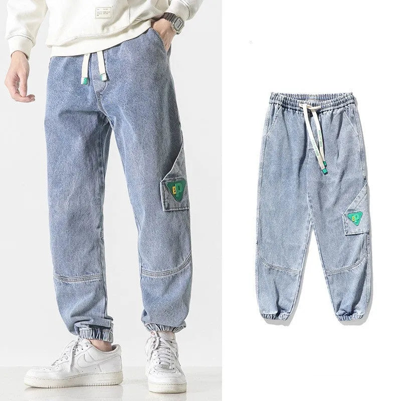 Men's loose-fit tapered trousers in cotton fabric, available in black, blue, and grey colours