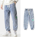 Men's loose-fit tapered trousers in cotton fabric, available in black, blue, and grey colours