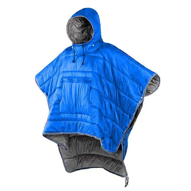 Adult wearing grey nylon cloak sleeping bag as wearable camping blanket outdoors