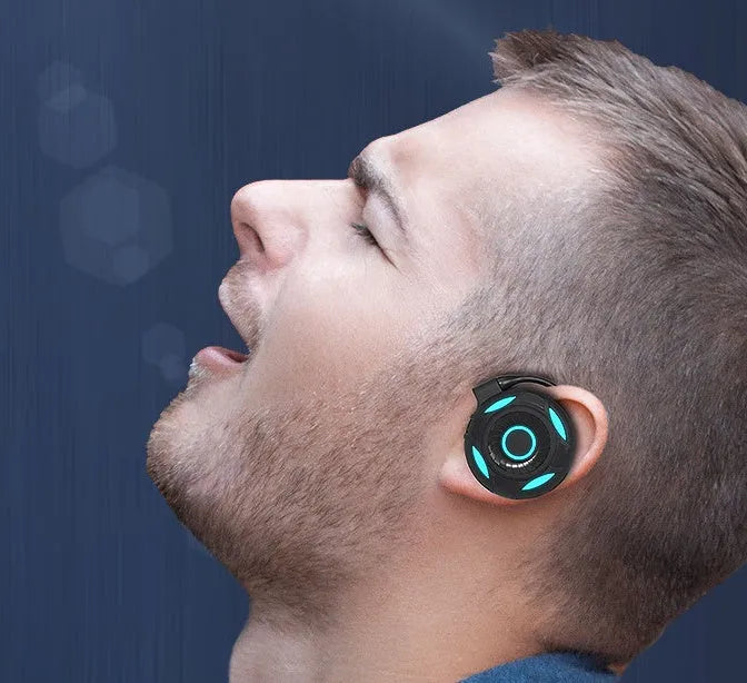Black and white wireless Bluetooth earphones with hanging ear design and USB charging
