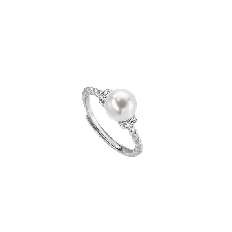 Adjustable antique-style copper ring with twisted geometric band and a pearl inlay centre.