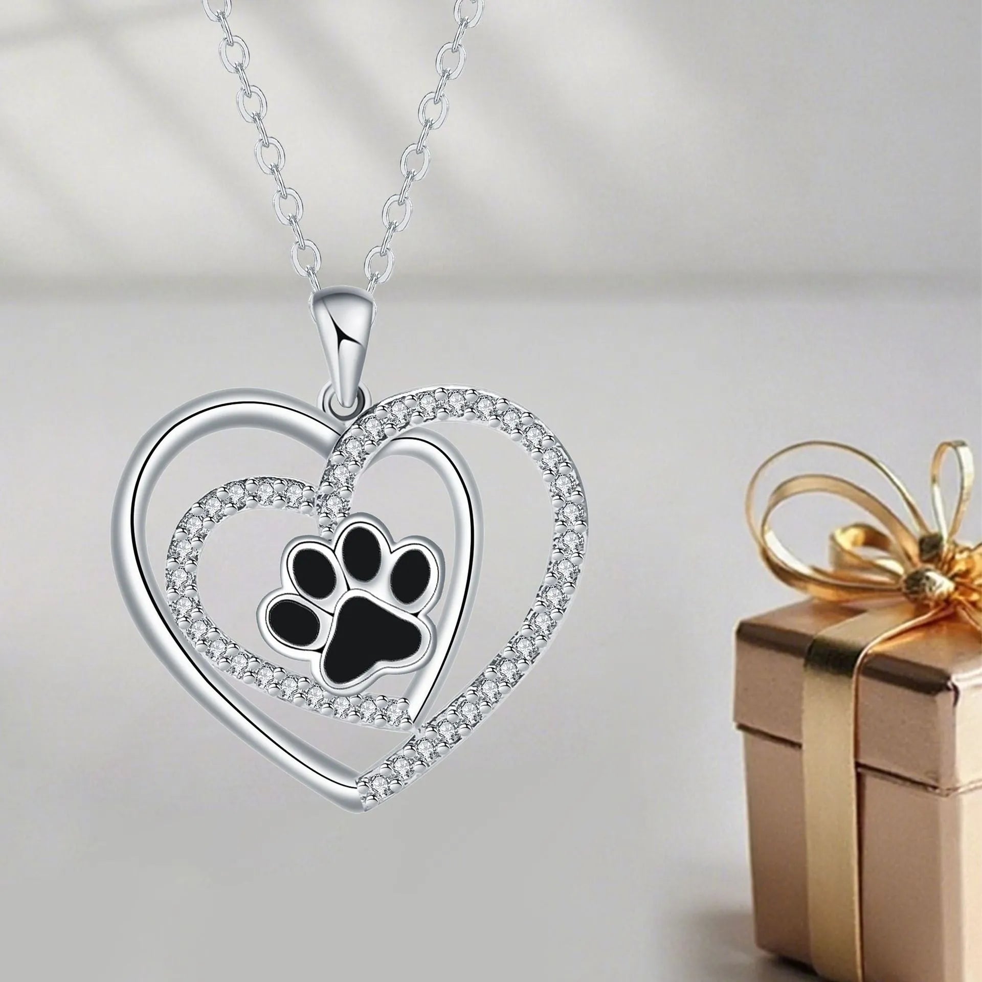 Close-up of a women's copper necklace with a heart-shaped dog's paw print pendant.