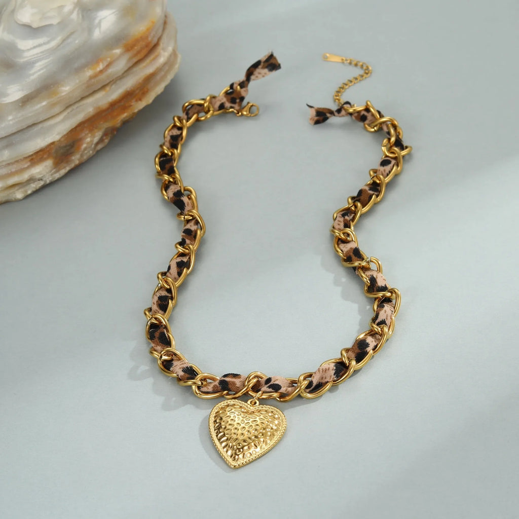 Stainless steel necklace with geometric leopard and heart pendant on adjustable chain