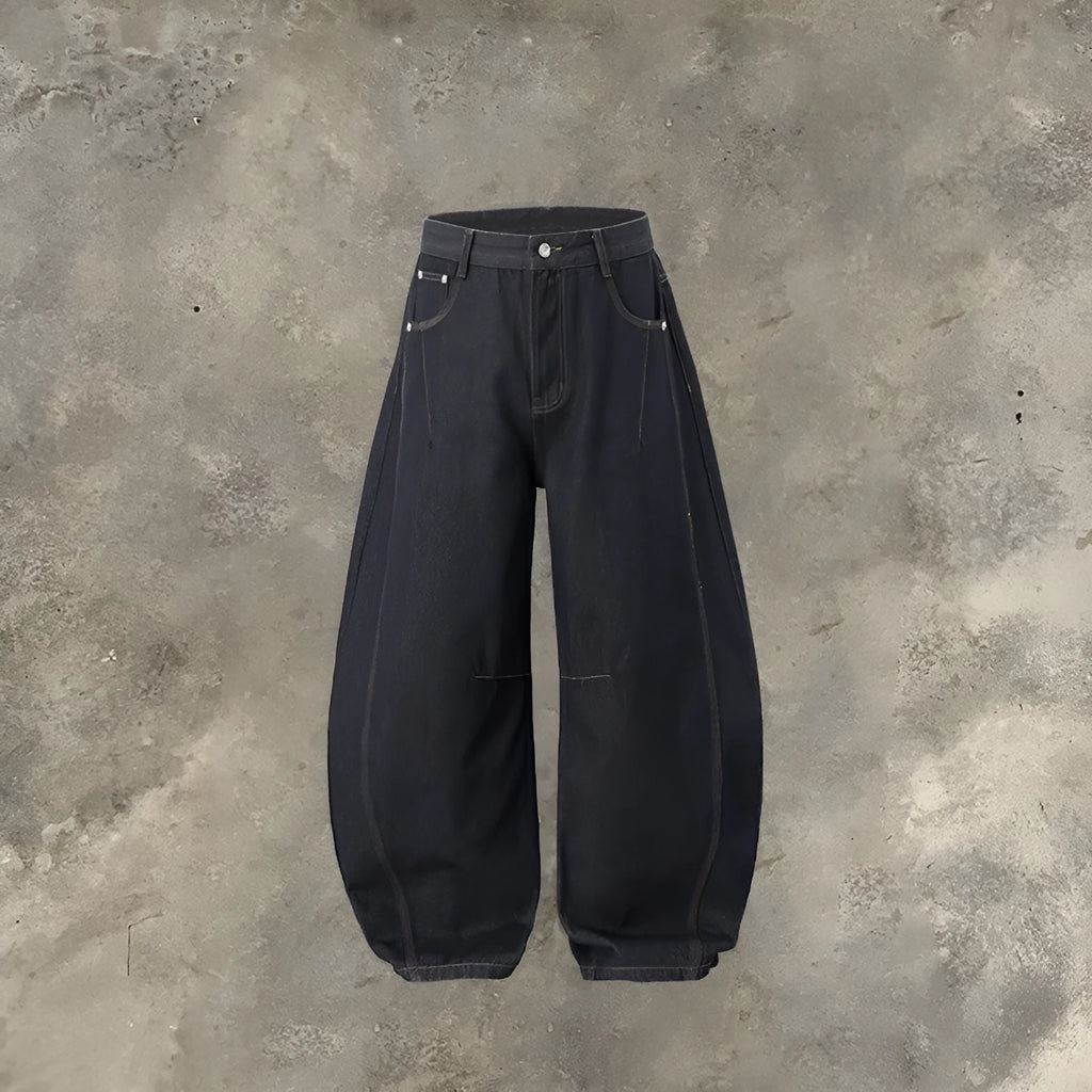 Men's wide leg denim trousers in original cow colour on a hanger, showing the relaxed fit and mid waist design.
