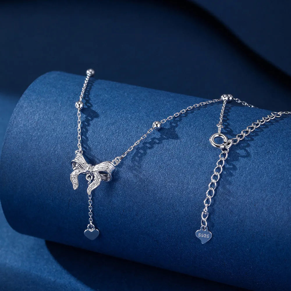 S925 silver necklace with heart-shaped pendant featuring butterfly and bow design on adjustable O-ring chain