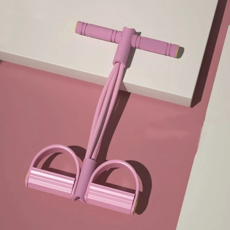 Yoga four-piece fitness set showing leg stretcher, ring, pedal device, and tension rope on a floor.