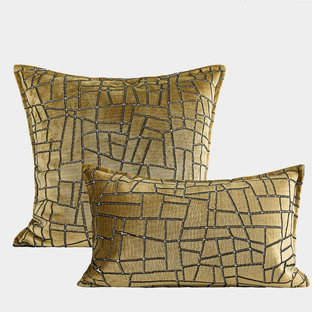 Gold and white abstract geometric patterned cushion cover on a grey sofa, showing 45x45cm square size option.