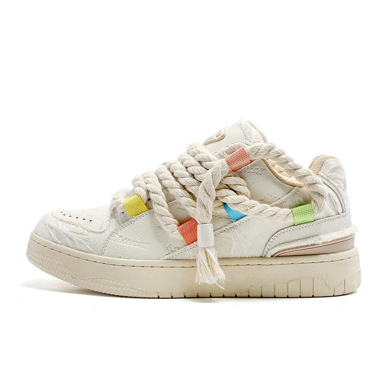 Creamy white low-top retro skate shoes with platform heel and lace-up design on a plain background.