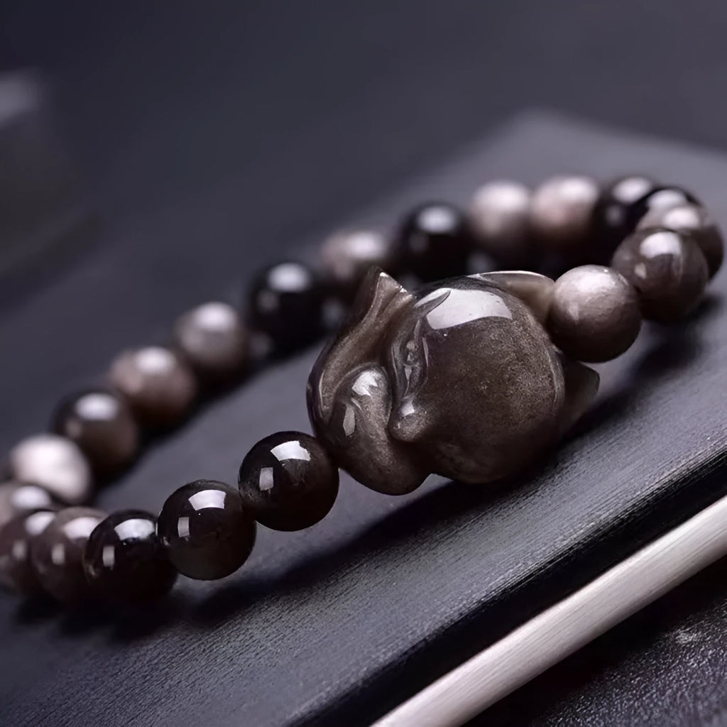 Obsidian fox single ring bracelet showing detailed fox carving on 8mm polished black stone band