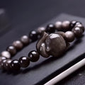 Obsidian fox single ring bracelet showing detailed fox carving on 8mm polished black stone band