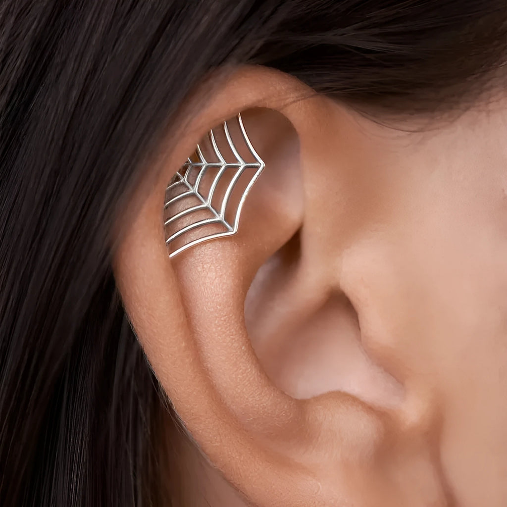 Spider web design stud earrings in gold and silver electroplated metal.