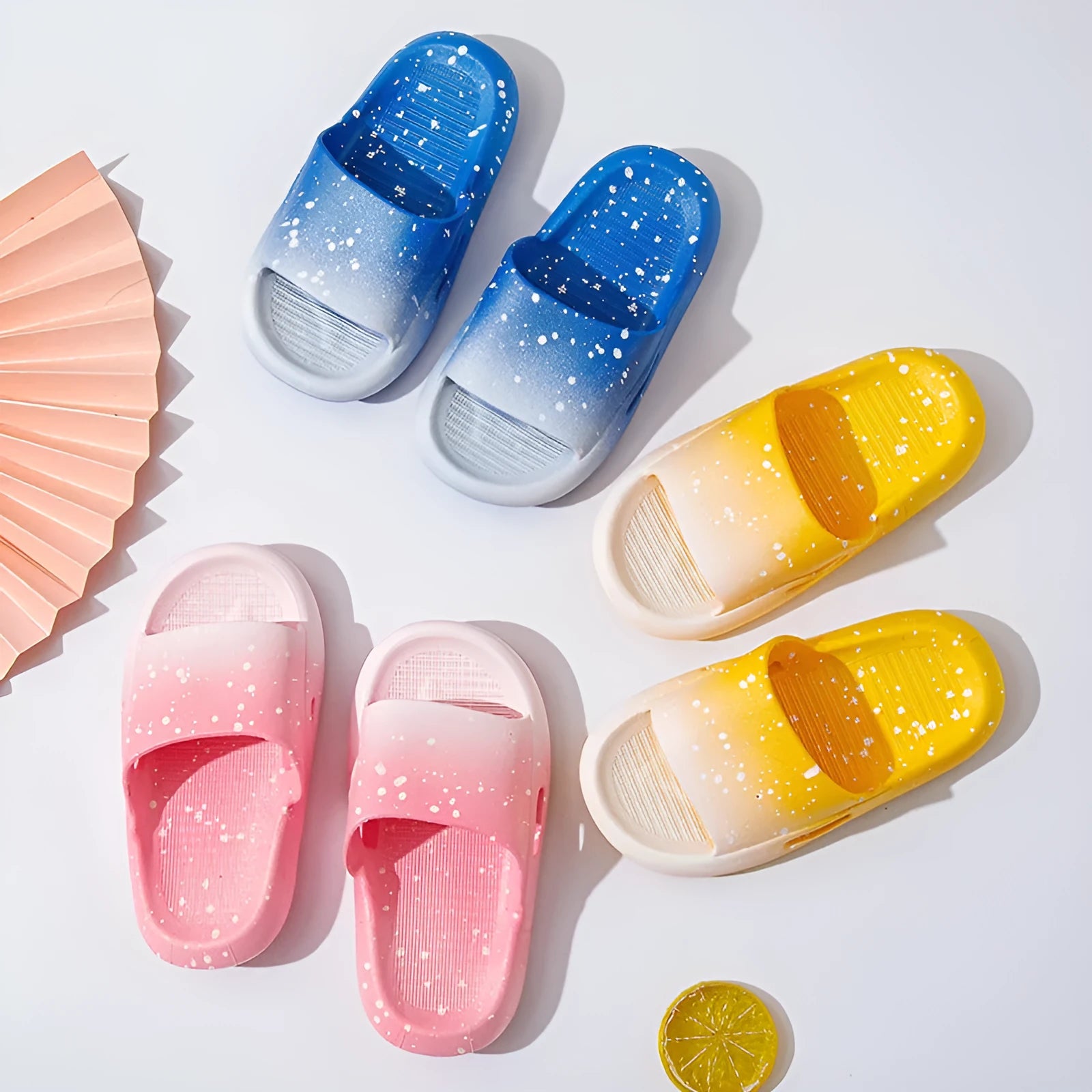 Gradient blue children's PVC summer slippers with a non-slip sole on a wooden deck.