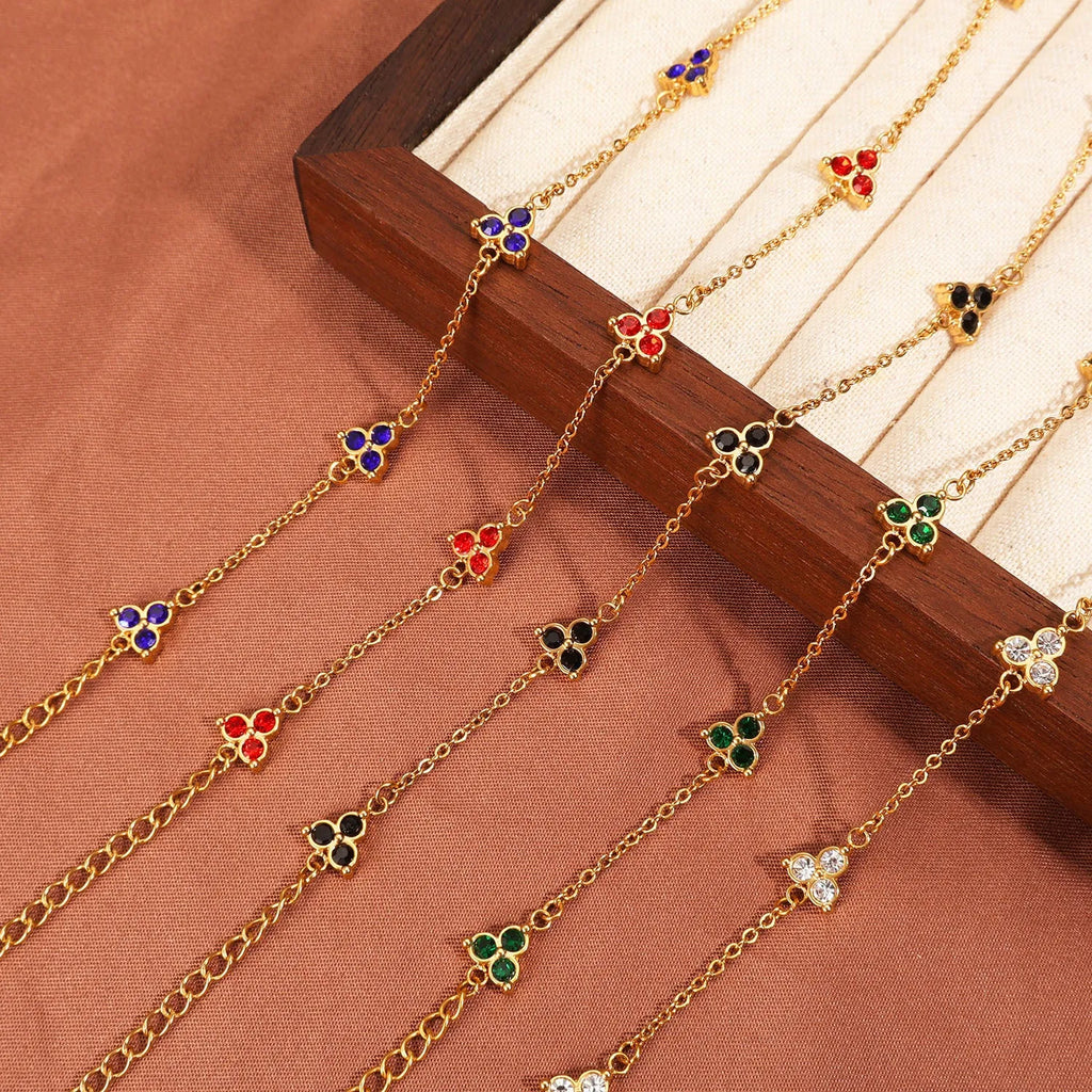 Women's geometric stainless steel bracelet with triangular diamond elements in gold or steel finish with coloured stones.