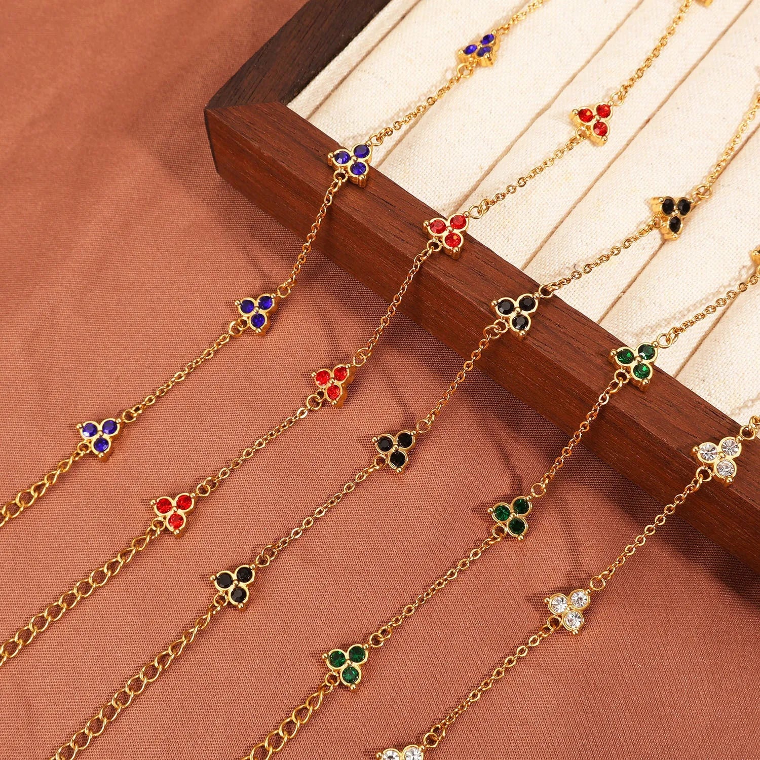 Women's geometric stainless steel bracelet with triangular diamond elements in gold or steel finish with coloured stones.