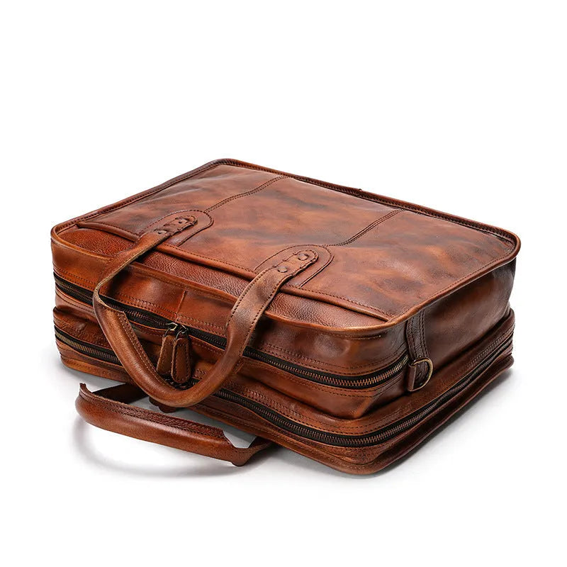 Men's leather briefcase showing multiple interior organisational pockets including laptop compartment